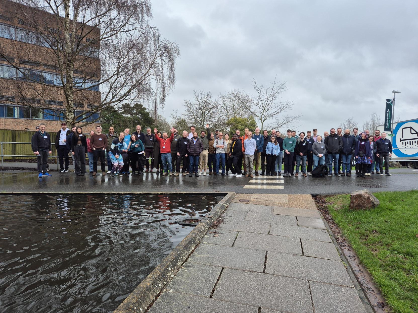 A large group of approximately  people standing outside the Peter Chalk Centre at the University of Exeter